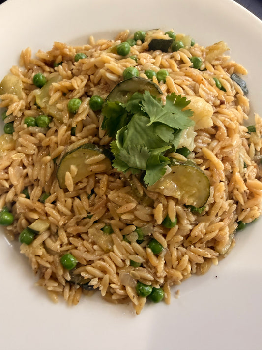 Orzo with Stir Fry Zucchini, Sweet Green Peas & Vegan Cheese Topping